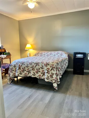 a bedroom with a bed and a lamp on dresser