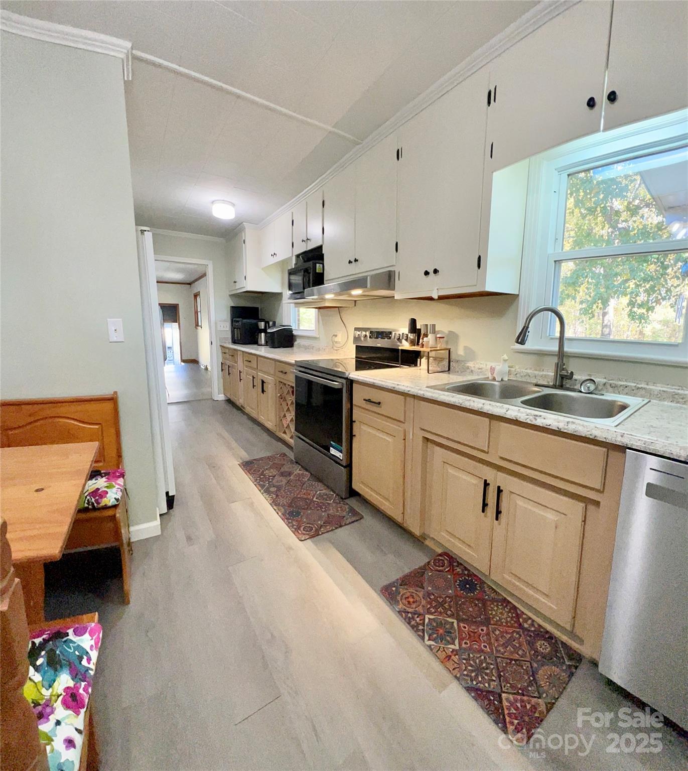 240 Hamrick Road Mooresboro, NC 28114 - Photo 20 of 23 a kitchen with stainless steel appliances granite countertop a sink dishwasher stove and white cabinets