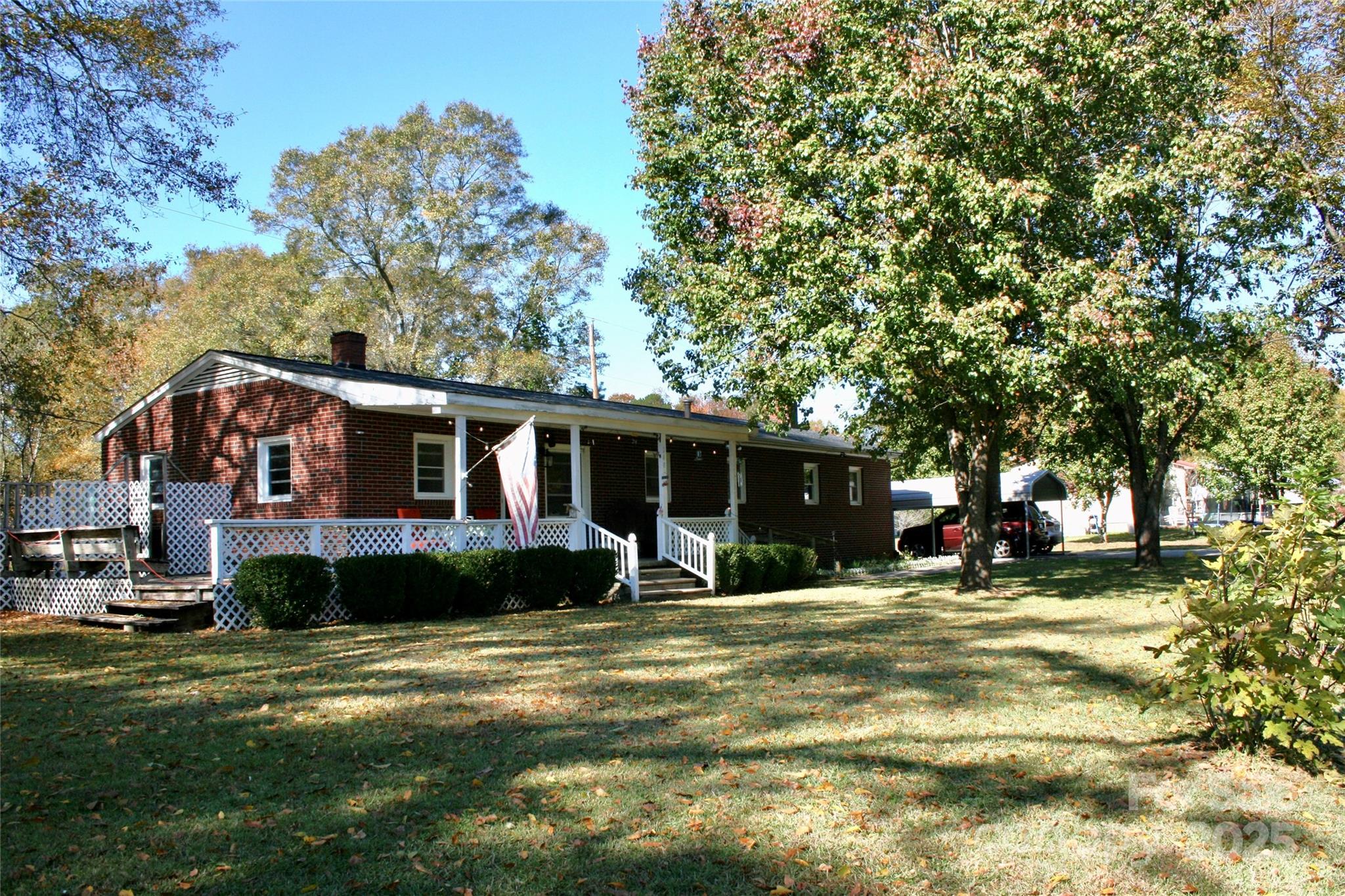 240 Hamrick Road Mooresboro, NC 28114 - Photo 3 of 23 a front view of a house with a yard and trees