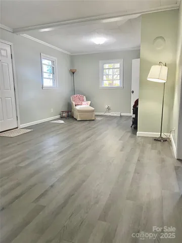 a view of a livingroom with wooden floor and window
