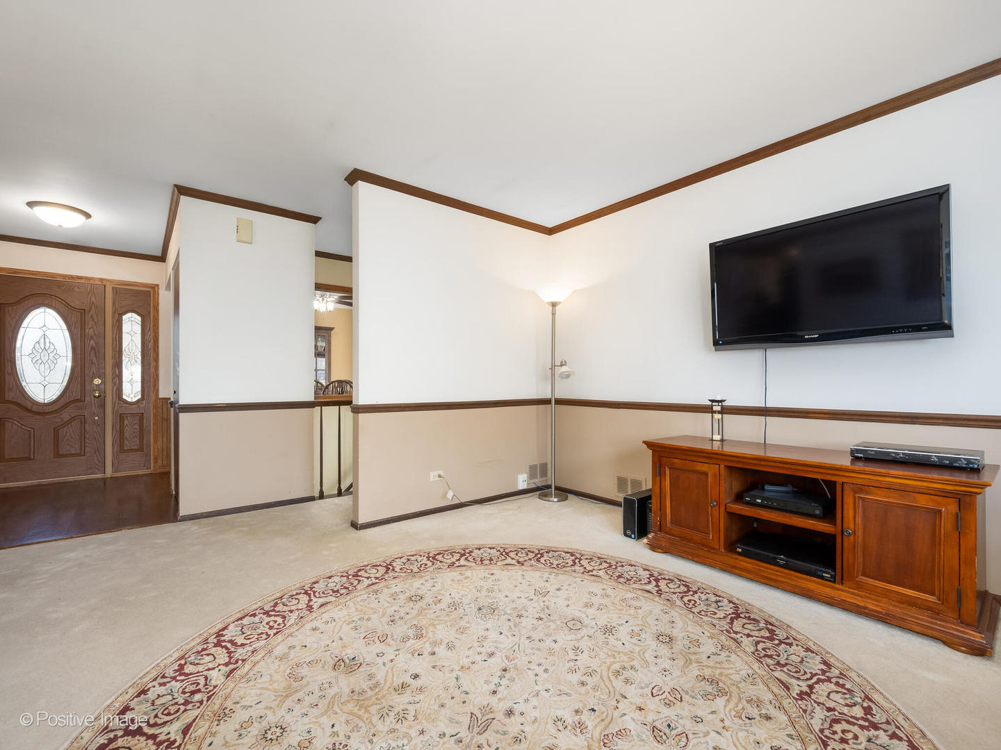 130 West End Road Roselle, IL 60172 - Photo 3 of 27 a view of a livingroom with furniture and a flat screen tv
