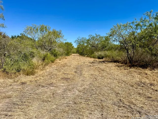 a view of a mountain view with wooden fence