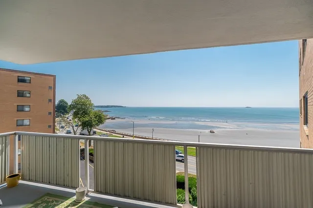 a bedroom with furniture and a large window