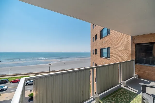 a bedroom with furniture and a large window