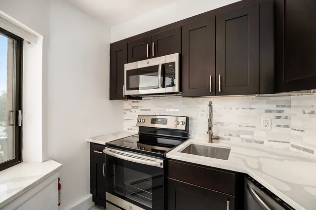 a bathroom with a sink mirror vanity and toilet