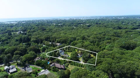 an aerial view of a house with a yard