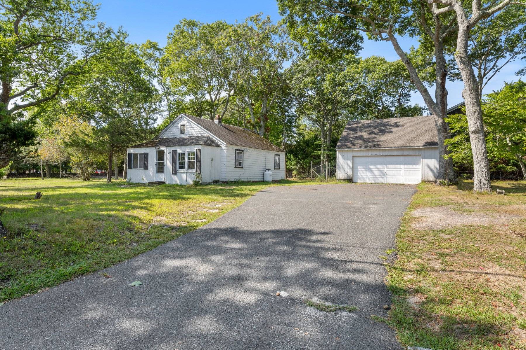 39 Foster Road Quogue, NY 11959 - Photo 10 of 13 a view of a house with a big yard and large trees