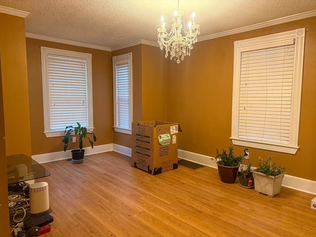 92 Spencer Street Boston, MA 02124 - Photo 11 of 34 a room with gym equipment and a large window