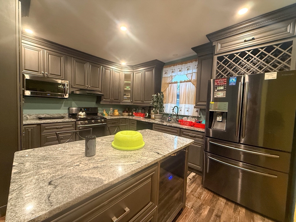92 Spencer Street Boston, MA 02124 - Photo 14 of 34 a kitchen with stainless steel appliances granite countertop a sink stove and refrigerator