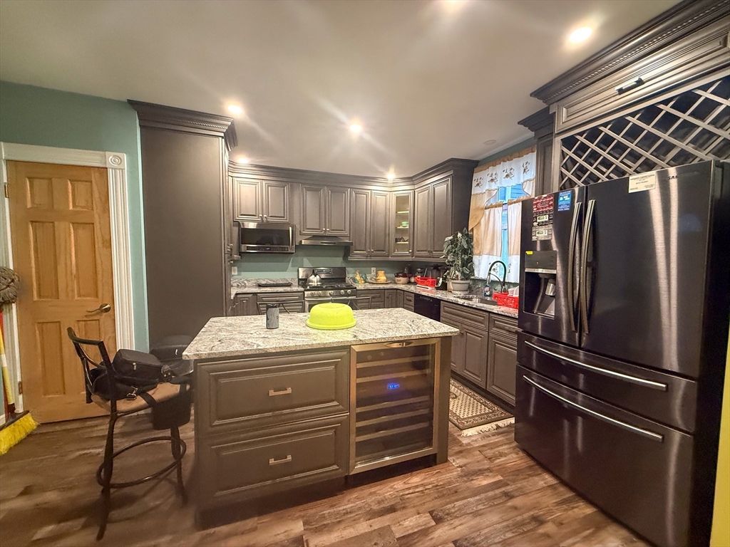92 Spencer Street Boston, MA 02124 - Photo 15 of 34 a kitchen with refrigerator and window