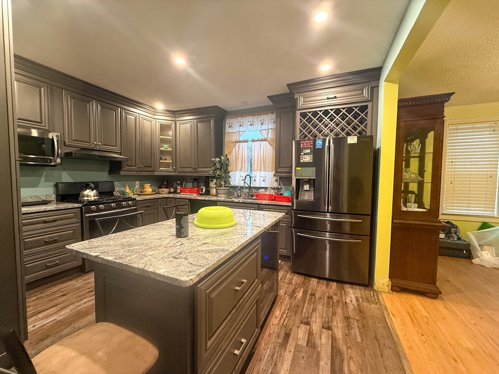 92 Spencer Street Boston, MA 02124 - Photo 16 of 34 a kitchen with stainless steel appliances granite countertop a refrigerator a sink and a stove