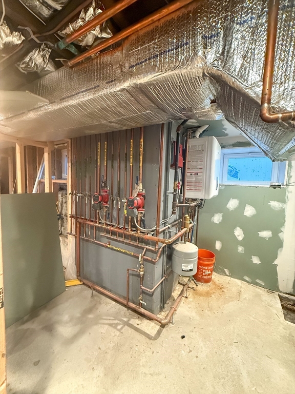 92 Spencer Street Boston, MA 02124 - Photo 32 of 34 a view of living room filled with furniture and a chandelier