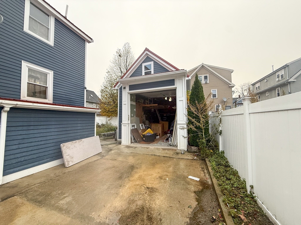 92 Spencer Street Boston, MA 02124 - Photo 7 of 34 a view of a chair and a fire pit in front of a house