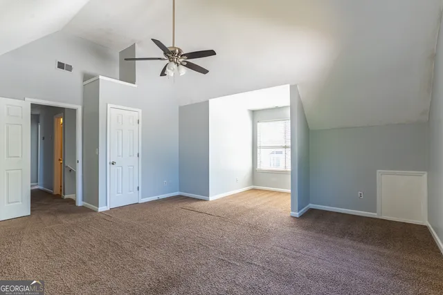 a view of empty room with ceiling fan
