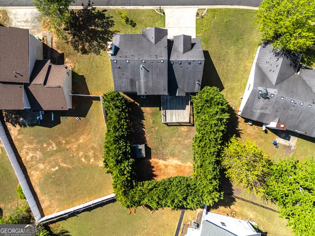 an aerial view of residential houses with outdoor space