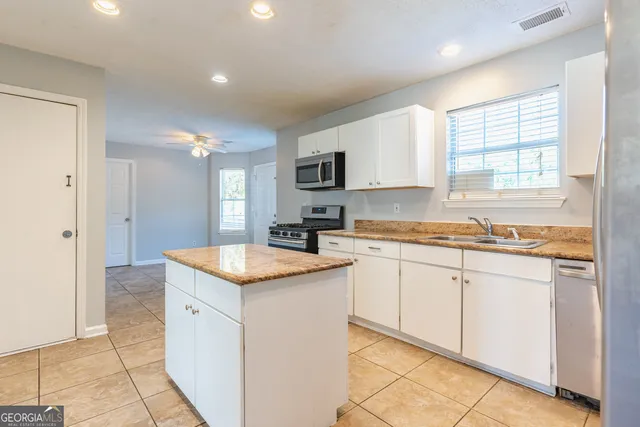 a kitchen that has a sink and a stove in it