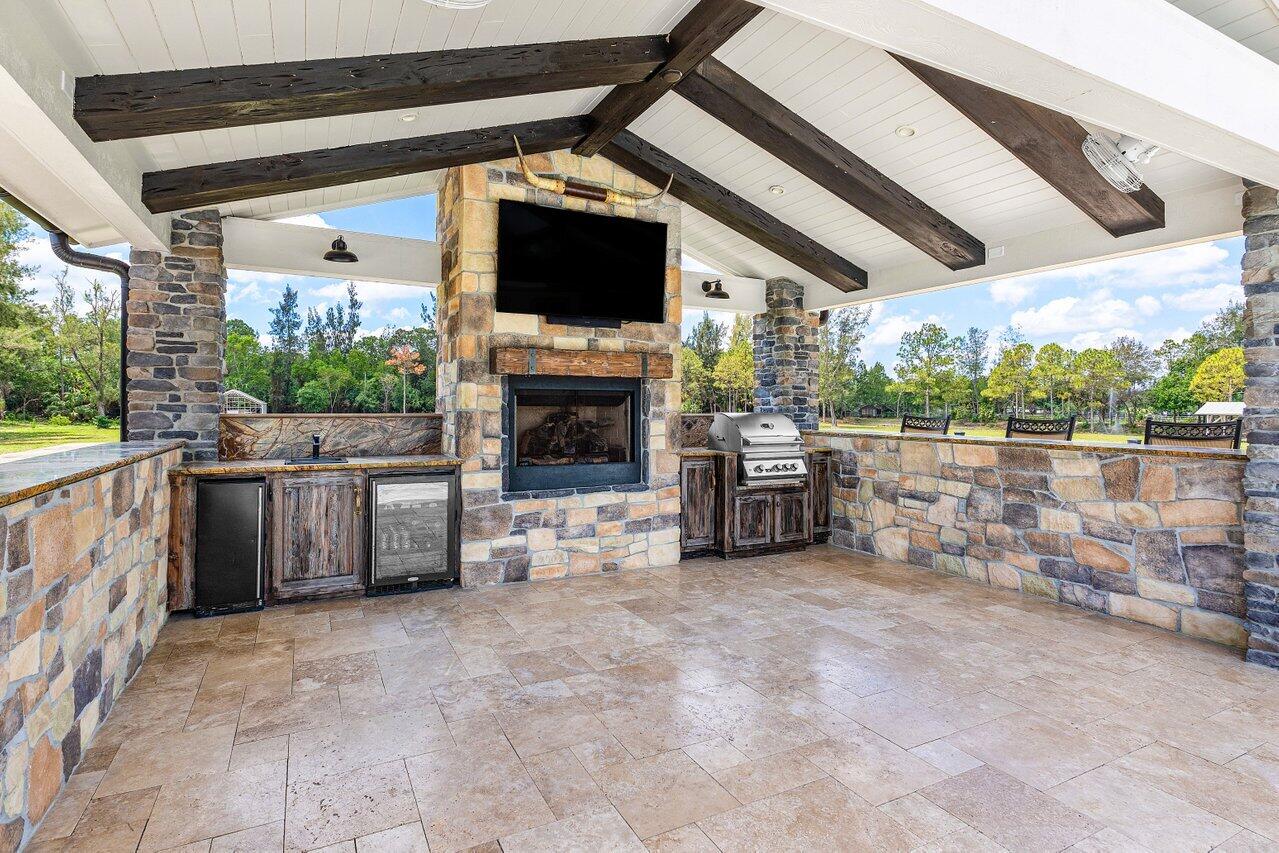 17270 Rocky Pines Road Jupiter, FL 33478 - Photo 13 of 69 a view of a porch with furniture and a fireplace