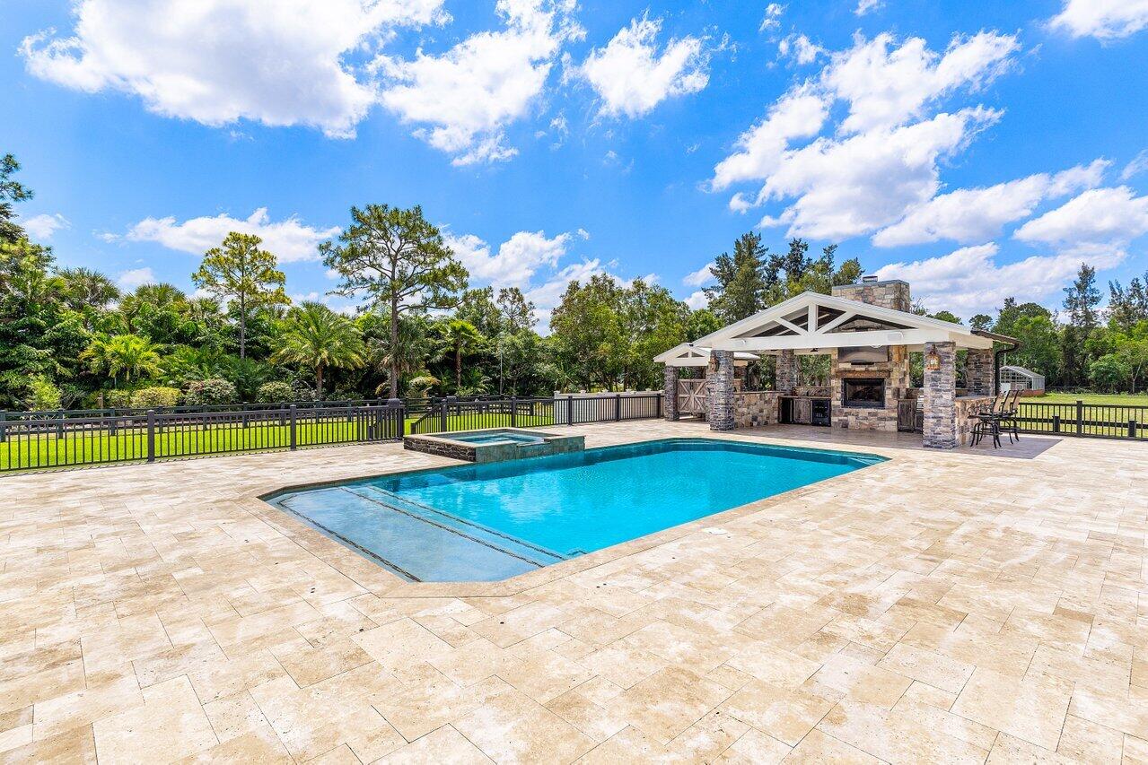 17270 Rocky Pines Road Jupiter, FL 33478 - Photo 15 of 69 a view of a swimming pool with a yard