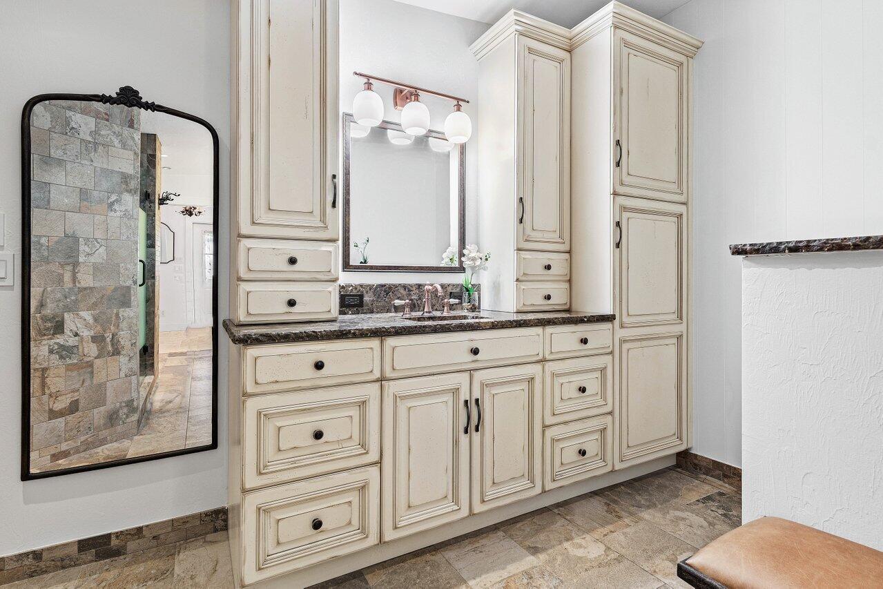 17270 Rocky Pines Road Jupiter, FL 33478 - Photo 22 of 69 a bathroom with a granite countertop sink and a mirror