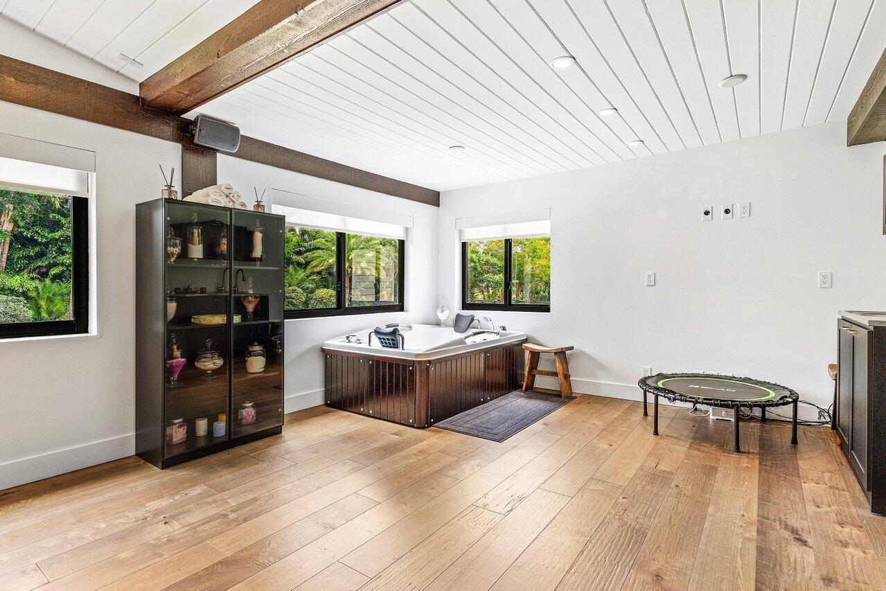 17270 Rocky Pines Road Jupiter, FL 33478 - Photo 25 of 69 a living room with furniture and a wooden floor