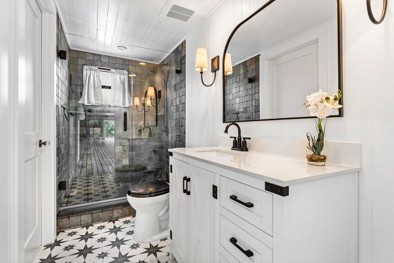 17270 Rocky Pines Road Jupiter, FL 33478 - Photo 29 of 69 a bathroom with a sink mirror and toilet