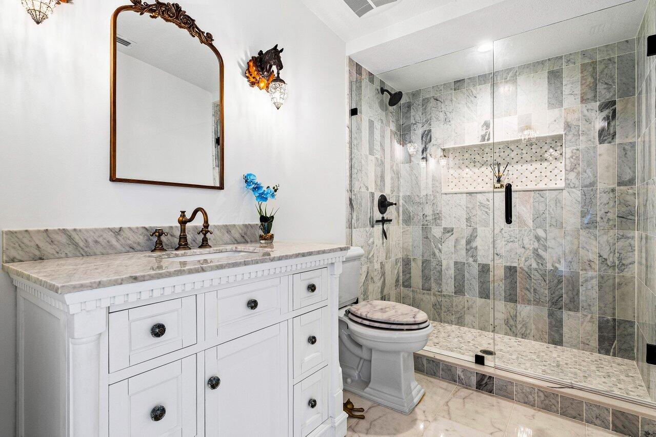 17270 Rocky Pines Road Jupiter, FL 33478 - Photo 30 of 69 a bathroom with a granite countertop sink toilet and shower