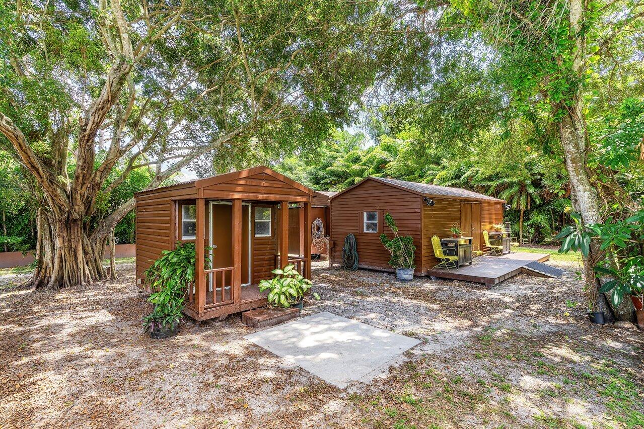 17270 Rocky Pines Road Jupiter, FL 33478 - Photo 37 of 69 a front view of a house with garden