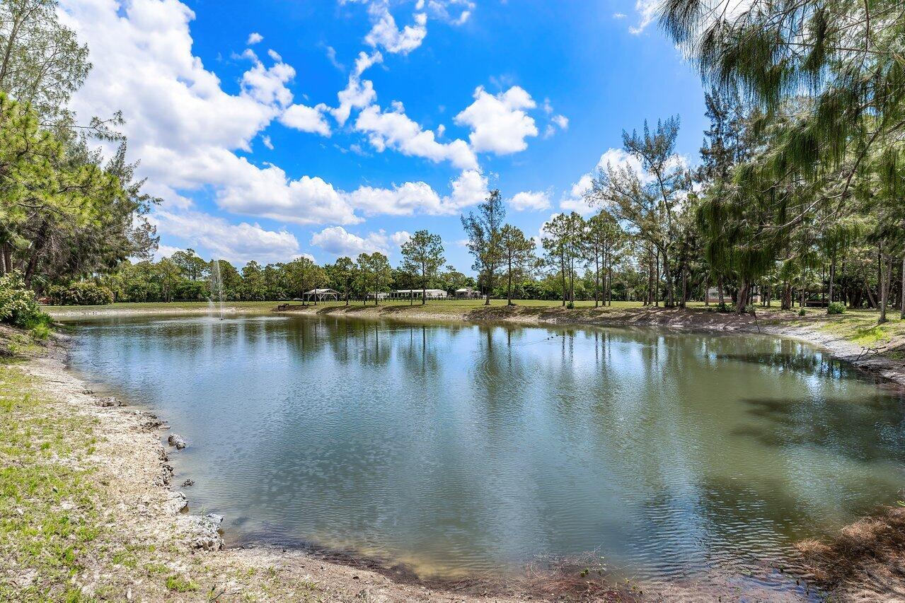 17270 Rocky Pines Road Jupiter, FL 33478 - Photo 40 of 69 a view of a lake with houses in the background