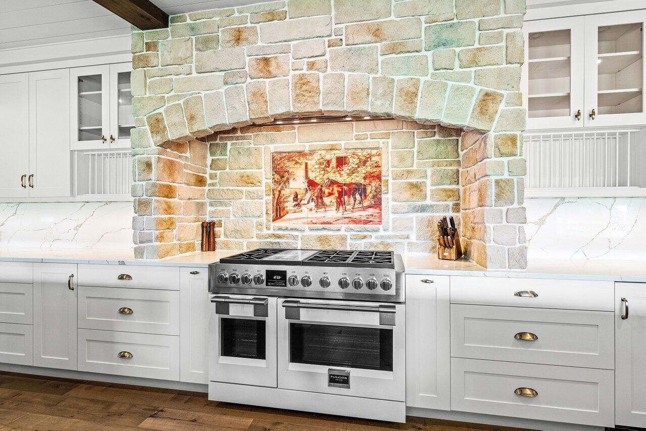 17270 Rocky Pines Road Jupiter, FL 33478 - Photo 4 of 69 a stove top oven sitting inside of a kitchen