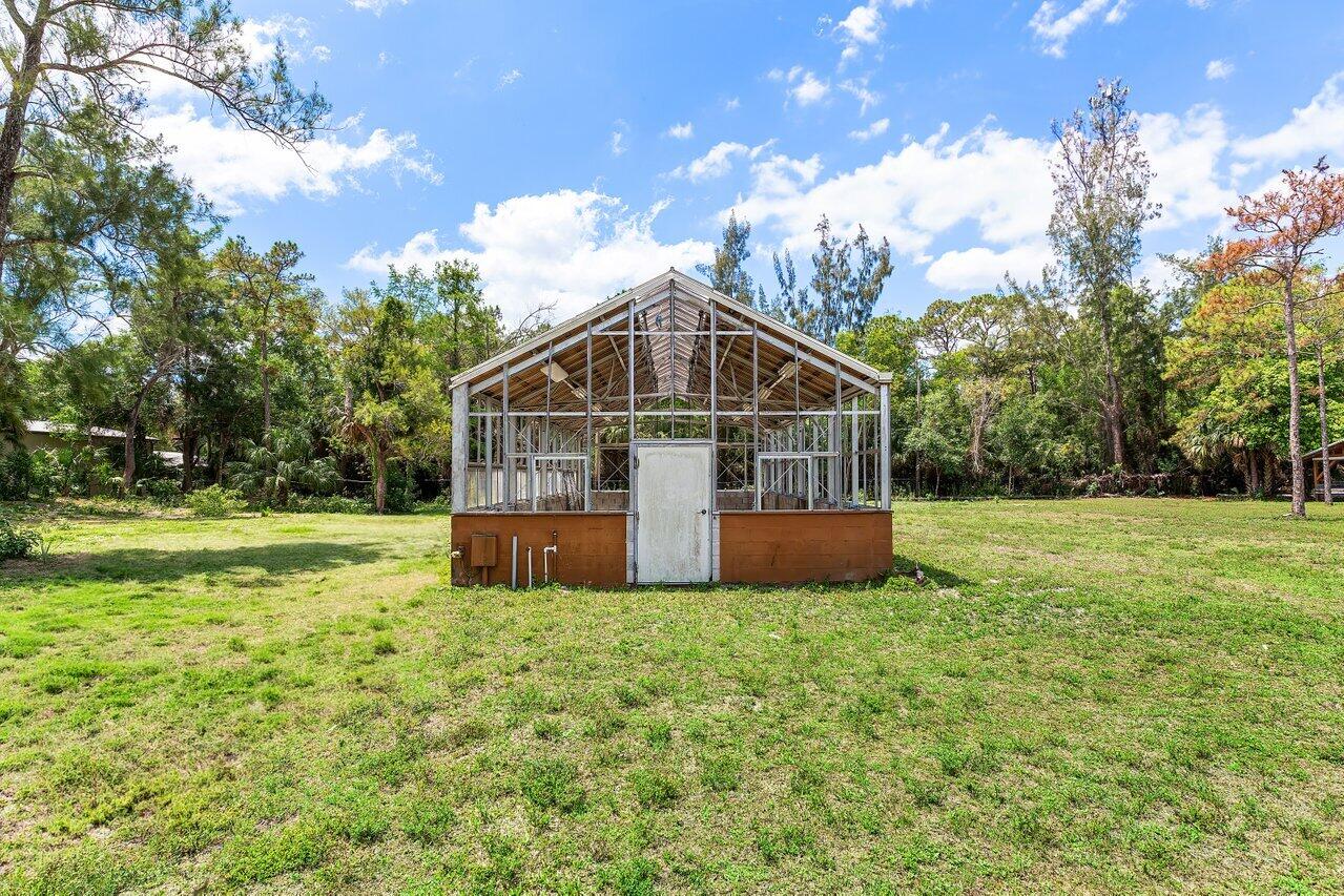 17270 Rocky Pines Road Jupiter, FL 33478 - Photo 45 of 69 a view of a house with a yard