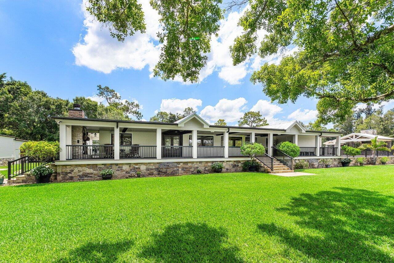 17270 Rocky Pines Road Jupiter, FL 33478 - Photo 47 of 69 a front view of building with yard and green space