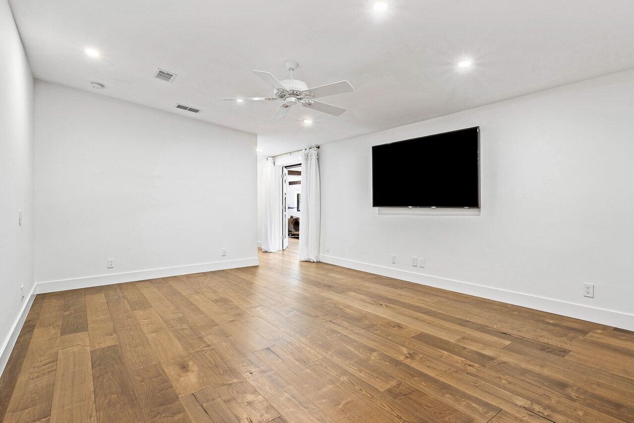 17270 Rocky Pines Road Jupiter, FL 33478 - Photo 54 of 69 an empty room with wooden floor and windows
