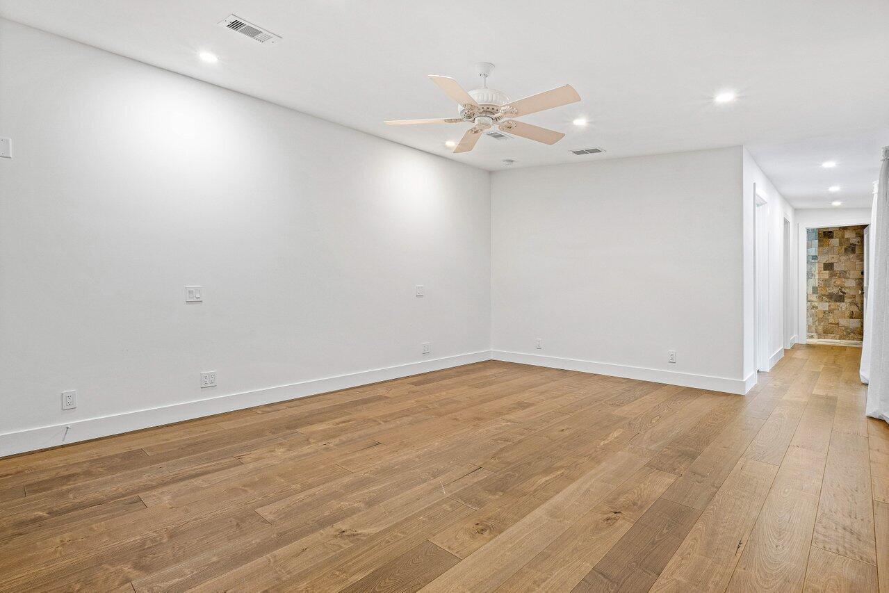 17270 Rocky Pines Road Jupiter, FL 33478 - Photo 55 of 69 an empty room with wooden floor and fan