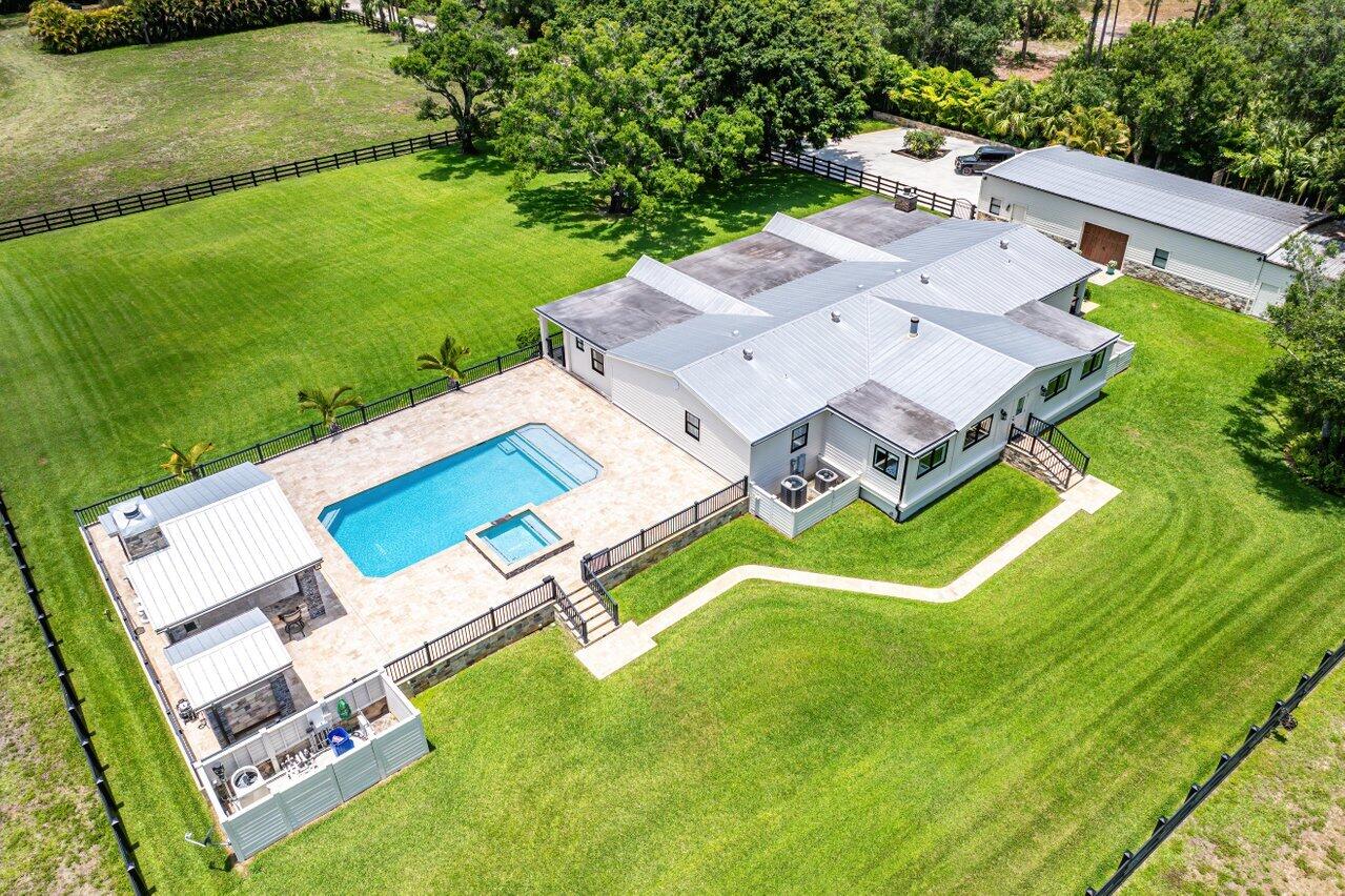 17270 Rocky Pines Road Jupiter, FL 33478 - Photo 57 of 69 an aerial view of residential house with outdoor space and swimming pool