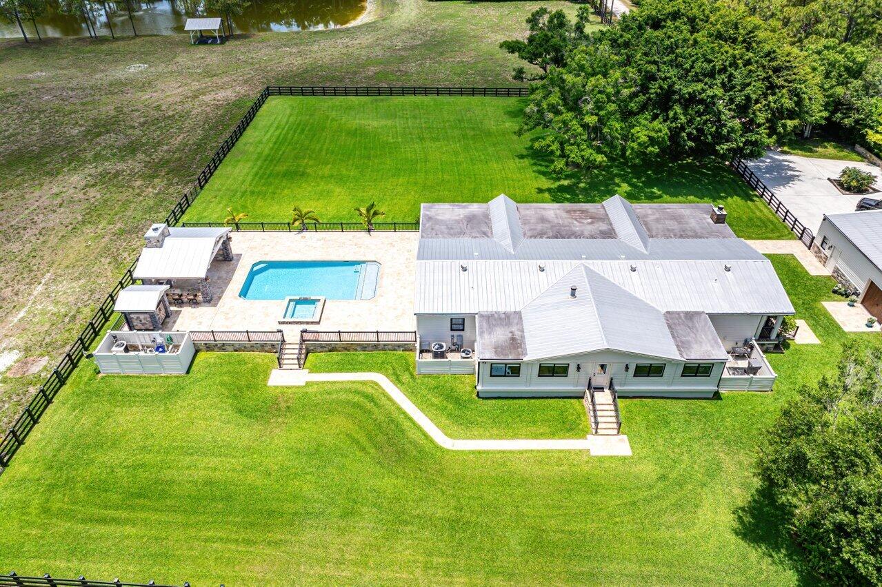 17270 Rocky Pines Road Jupiter, FL 33478 - Photo 58 of 69 an aerial view of a house with swimming pool garden and trees