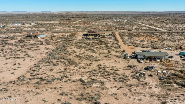 a living room with furniture and large windows