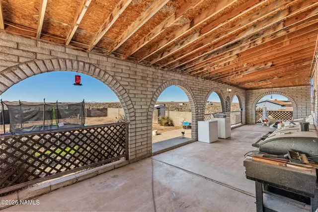a bedroom with a bed and a flat tv screen on wall