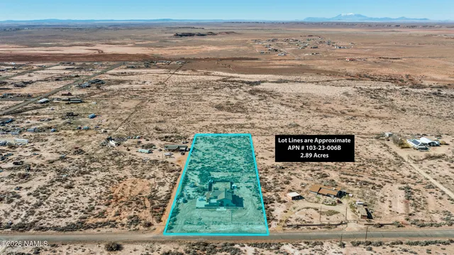 a view of a patio with a dining table and chairs with wooden floor