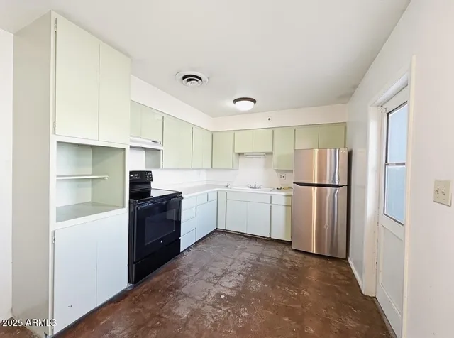 a kitchen with white cabinets and white appliances