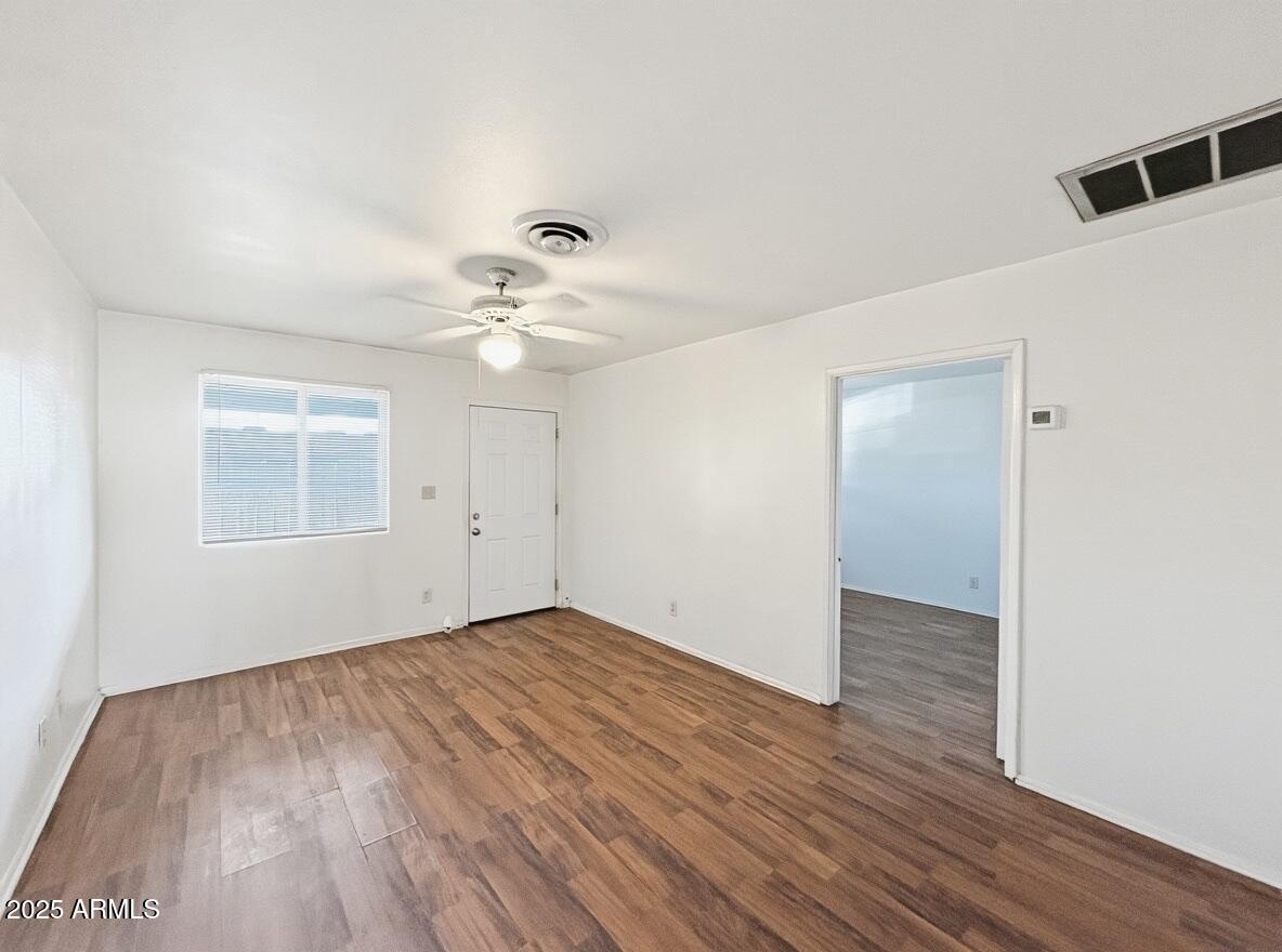 513 East Hatcher Road, Unit 9 Phoenix, AZ 85020 - Photo 4 of 10 a view of an empty room with wooden floor