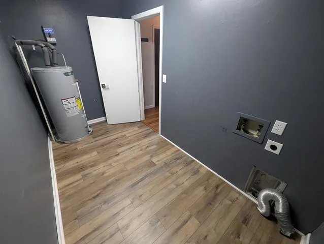 a view of a livingroom with wooden floor and stairs