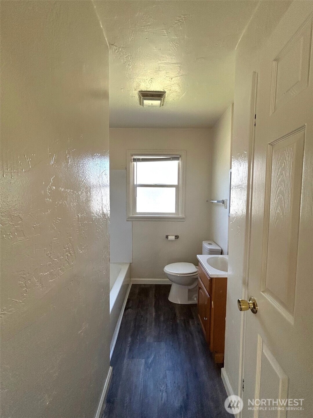 2914 Washington Way Longview, WA 98632 - Photo 11 of 17 a bathroom with a toilet a sink a window and wooden floor