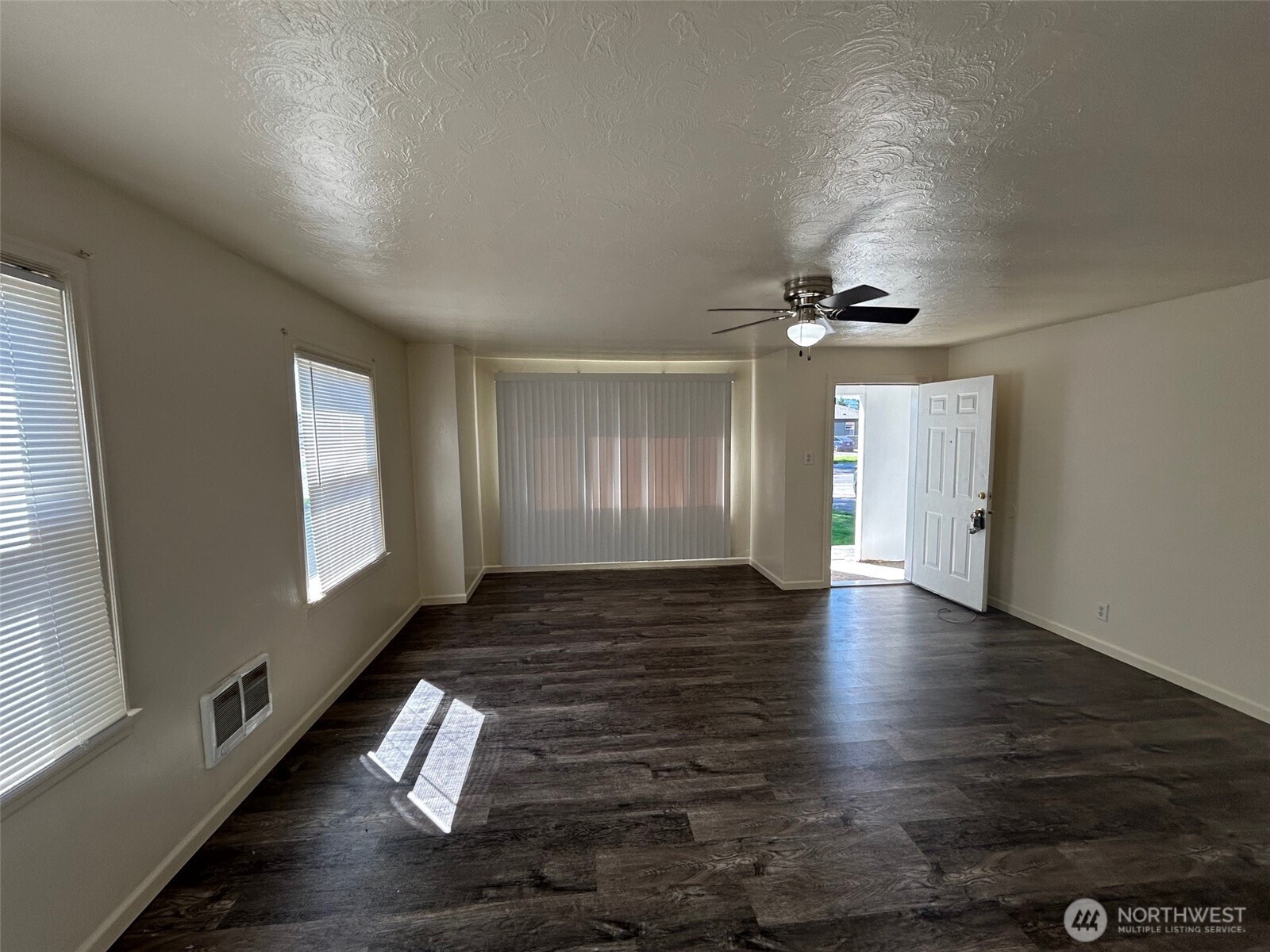 2914 Washington Way Longview, WA 98632 - Photo 3 of 17 a view of an empty room with wooden floor and a window