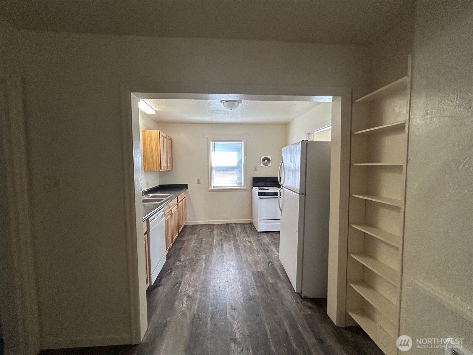 2914 Washington Way Longview, WA 98632 - Photo 8 of 17 a view of a hallway with wooden floor and a living room