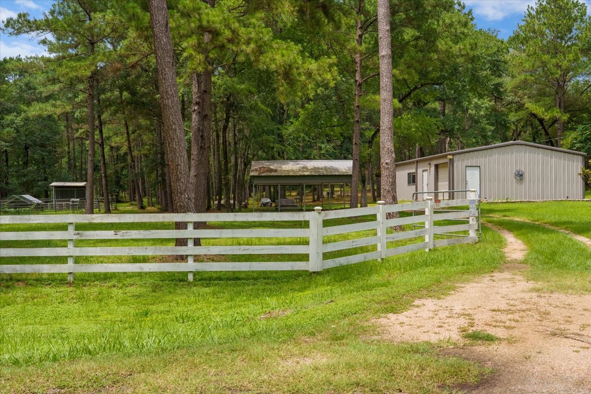 16375 Grand Flower Road Plantersville, TX 77363 - Photo 48 of 50 a view of a house with a yard