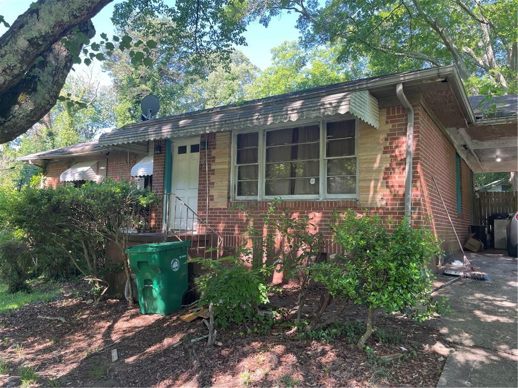 2195 Sharon Way Decatur, GA 30032 - Photo 1 of 1 a house with a flower garden in front of it