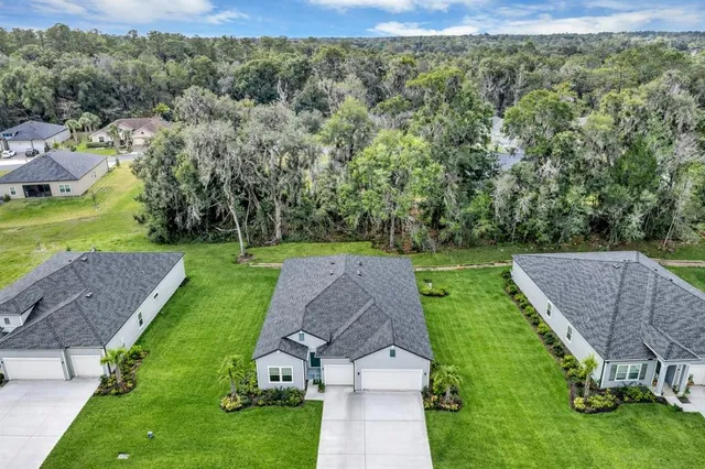 an aerial view of a house with big yard