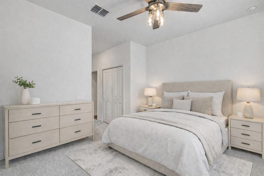 19438 Southwest 79th Street Dunnellon, FL 34432 - Photo 12 of 34 a bedroom with a bed and a chandelier