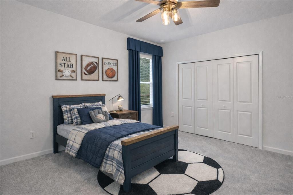 19438 Southwest 79th Street Dunnellon, FL 34432 - Photo 14 of 34 a bedroom with a bed and a chandelier