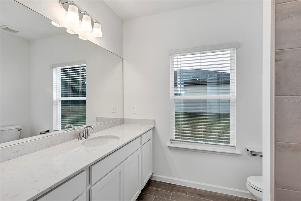 19438 Southwest 79th Street Dunnellon, FL 34432 - Photo 15 of 34 a bathroom with a sink a toilet and a window